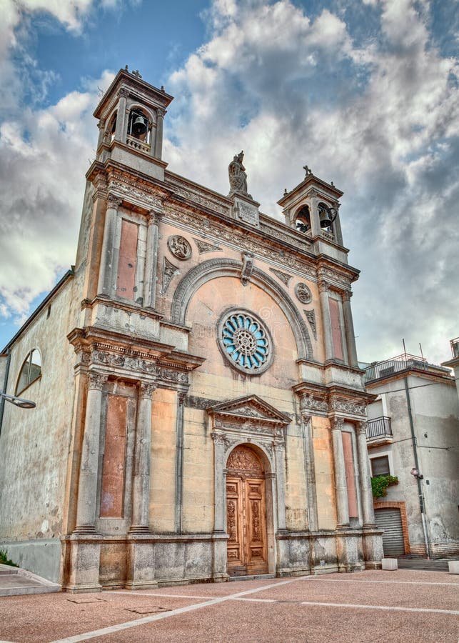 Historic church facade beneath a clouded sky