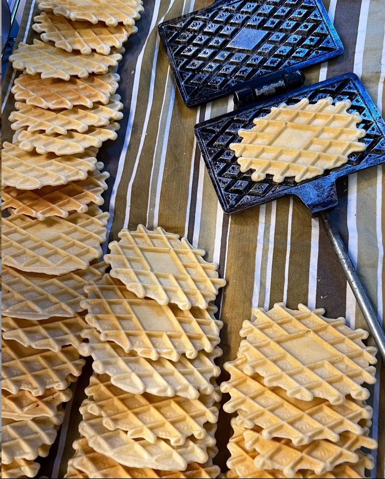 Ferratelle beside traditional patterned irons