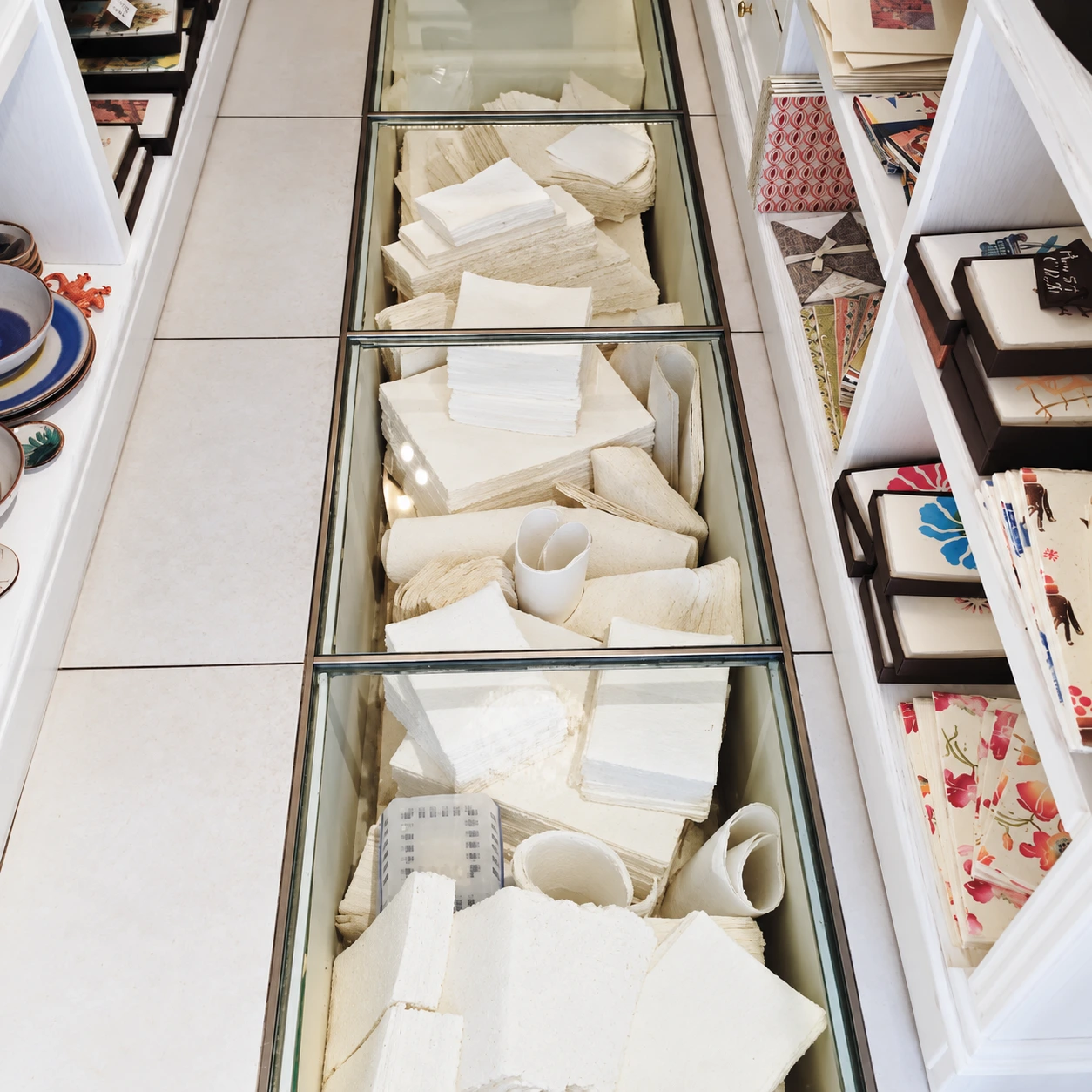 Ivory paper with textured edges displayed beneath glass in an Amalfi stationery shop