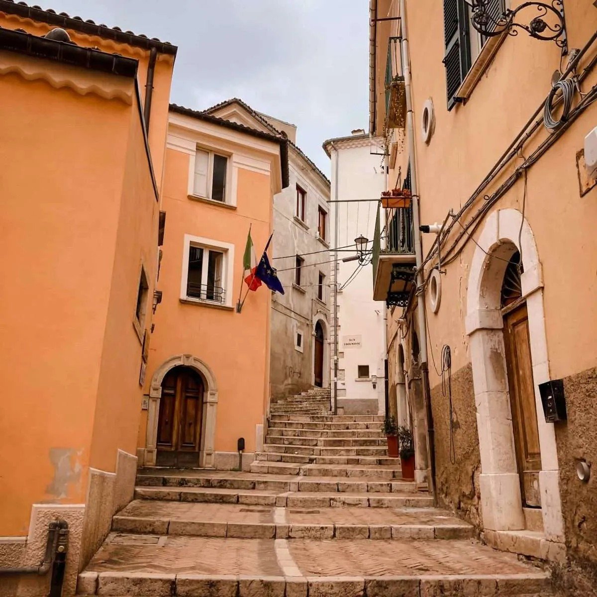 Stone steps winding between warm ochre houses in a Molise hill town