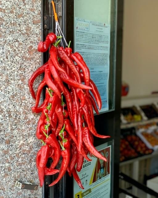 Red pepone peppers hanging beside a shop doorway
